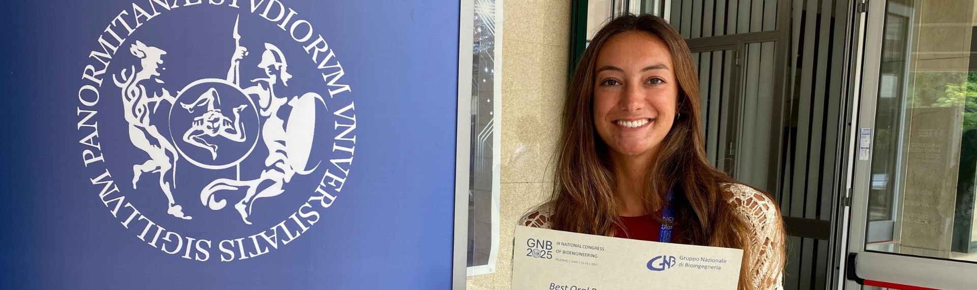 A woman is holding a certificate in front of an information board. A woman is holding a certificate in front of an information board.
