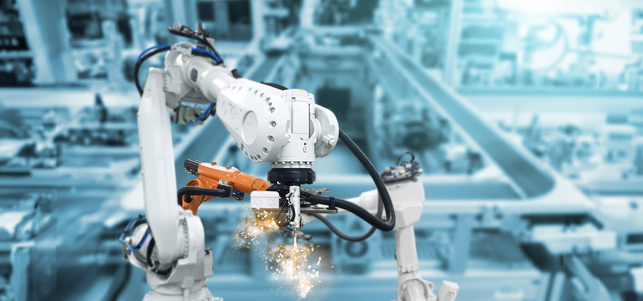 A robot working on a car inside a factory.